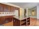 Kitchen with wood cabinets, center island with granite countertop, tile backsplash, and hardwood floors at 1132 Hargrove Ct, Locust Grove, GA 30248