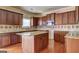 Kitchen with wood cabinets, granite countertops, stainless steel appliances, and hardwood floors at 1132 Hargrove Ct, Locust Grove, GA 30248