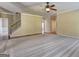 Open living room featuring hardwood floors and staircase access at 1132 Hargrove Ct, Locust Grove, GA 30248