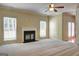 Bright living room with fireplace, ceiling fan, and large windows at 1132 Hargrove Ct, Locust Grove, GA 30248