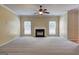 Spacious living room featuring a fireplace and a ceiling fan at 1132 Hargrove Ct, Locust Grove, GA 30248
