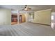 Open-concept living room with hardwood floors and view of kitchen at 1132 Hargrove Ct, Locust Grove, GA 30248