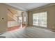 Bright living room with neutral walls, staircase, large front window, and carpet flooring at 1132 Hargrove Ct, Locust Grove, GA 30248