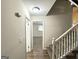 Hallway featuring staircase and bedroom doorway with carpet and vinyl flooring at 3158 Wisteria Way, East Point, GA 30344