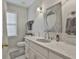 Well-lit bathroom with a decorative mirror, quartz countertops, modern fixtures, and a shower/tub combo at 505 Bracken Edge, Peachtree City, GA 30269