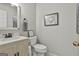 Half bathroom featuring modern fixtures, gray accents, and a stylish mirror at 505 Bracken Edge, Peachtree City, GA 30269
