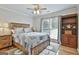 Inviting bedroom with a ceiling fan, natural light, hardwood floors, and a bookcase at 505 Bracken Edge, Peachtree City, GA 30269