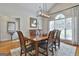 Well-lit dining room featuring a wooden dining set, an area rug, and a hutch against a wall at 505 Bracken Edge, Peachtree City, GA 30269