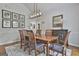 Spacious dining room with tasteful decor, including botanical art, a buffet, and a modern light fixture at 505 Bracken Edge, Peachtree City, GA 30269