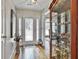 Bright foyer with hardwood floors, a glass cabinet and a glimpse of the dining room in the background at 505 Bracken Edge, Peachtree City, GA 30269