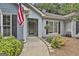 Inviting front entrance with a decorative glass door, sidelights, and an American flag proudly displayed at 505 Bracken Edge, Peachtree City, GA 30269