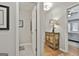 Hallway featuring a decorative cabinet with a lamp, and views to a bedroom and bathroom at 505 Bracken Edge, Peachtree City, GA 30269