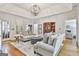 Comfortable living room with hardwood floors, neutral-toned sofas, and a modern light fixture for a cozy ambiance at 505 Bracken Edge, Peachtree City, GA 30269