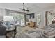 Cozy living room with large windows, ceiling fan, and modern furnishings at 505 Bracken Edge, Peachtree City, GA 30269