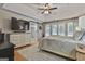 Bright main bedroom featuring a ceiling fan, a decorative rug, and sliding barn door access to bath at 505 Bracken Edge, Peachtree City, GA 30269
