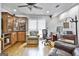Well-lit office with hardwood floors, built-in bar, and a comfortable seating area at 505 Bracken Edge, Peachtree City, GA 30269