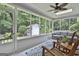 Cozy screened-in porch with comfortable seating and beautiful views of the backyard at 505 Bracken Edge, Peachtree City, GA 30269