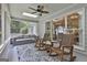 Relaxing sunroom featuring rocking chairs, comfortable couch, and large windows with backyard views at 505 Bracken Edge, Peachtree City, GA 30269