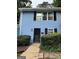 Charming blue townhome featuring black shutters, a black front door, and well-maintained landscaping at 375 Leisure Sw Ct, Marietta, GA 30064