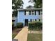 Charming blue townhome featuring black shutters, a black front door, and well-maintained landscaping at 375 Leisure Sw Ct, Marietta, GA 30064