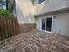 Back patio offers privacy fencing, stone flooring, and a sliding glass door to the home's interior at 292 Twiggs Cor, Peachtree City, GA 30269