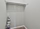 A closet with hardwood floors contains multiple cans of paint and a hanging rack at 292 Twiggs Cor, Peachtree City, GA 30269