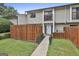 Charming townhouse featuring a fenced front yard, balcony, and well-maintained landscaping at 292 Twiggs Cor, Peachtree City, GA 30269