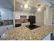 Updated kitchen with granite countertops, modern black appliances, and ample cabinet space at 292 Twiggs Cor, Peachtree City, GA 30269