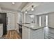 Kitchen island with granite countertops, electric cooktop, and white wood paneling detail at 292 Twiggs Cor, Peachtree City, GA 30269