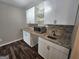 Well-lit kitchenette features custom cabinets, stylish countertops, and modern fixtures at 292 Twiggs Cor, Peachtree City, GA 30269
