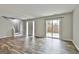 Bright, open-concept living room with hardwood floors, leading to staircase and backyard patio at 292 Twiggs Cor, Peachtree City, GA 30269