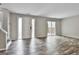 Bright living room featuring hardwood floors, a white front door, and sliding glass door to backyard at 292 Twiggs Cor, Peachtree City, GA 30269