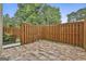 Private patio with stylish flooring, surrounded by a wood fence for added seclusion at 292 Twiggs Cor, Peachtree City, GA 30269