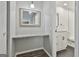 Charming vanity with granite countertop and framed mirror sits near the bathroom at 292 Twiggs Cor, Peachtree City, GA 30269