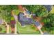Aerial view of a beautiful home with pool, lush landscaping, and a patio area surrounded by mature trees at 4030 River Ridge Chase Se, Marietta, GA 30067