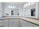 Bathroom with double vanity, granite countertops, modern mirrors, and cabinet storage at 4030 River Ridge Chase Se, Marietta, GA 30067