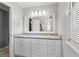 Bathroom with a white vanity, granite countertop, large mirror, and updated lighting fixtures at 4030 River Ridge Chase Se, Marietta, GA 30067