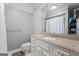 Bathroom with a single vanity, updated lighting, and modern fixtures with white tile flooring at 4030 River Ridge Chase Se, Marietta, GA 30067