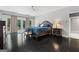 Spacious bedroom with hardwood floors, French doors, and a luxurious bed with matching nightstands at 4030 River Ridge Chase Se, Marietta, GA 30067