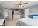 Bedroom features a ceiling fan, decorative wall art, carpeted floors, and access to bathroom at 4030 River Ridge Chase Se, Marietta, GA 30067
