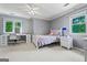 Cozy bedroom features a white bed frame, desk with rolling chair, and gray walls at 4030 River Ridge Chase Se, Marietta, GA 30067