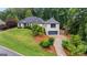 Beautiful home with manicured front yard, mature trees, and a three-car garage at 4030 River Ridge Chase Se, Marietta, GA 30067