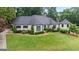Home featuring a manicured lawn and mature trees at 4030 River Ridge Chase Se, Marietta, GA 30067