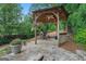 Outdoor gazebo featuring a grill, ceiling fan, and beautiful backyard views at 4030 River Ridge Chase Se, Marietta, GA 30067