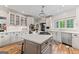 Well-lit kitchen features white cabinets, stainless steel appliances, and island with gas cooktop at 4030 River Ridge Chase Se, Marietta, GA 30067