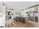 Spacious kitchen featuring white cabinets, stainless steel appliances, and a center island with bar stools at 4030 River Ridge Chase Se, Marietta, GA 30067