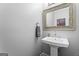 Elegant powder room featuring a pedestal sink with decorative mirror and fixtures at 4030 River Ridge Chase Se, Marietta, GA 30067
