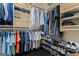 Organized walk-in closet with racks and shelves for shoes and folded shirts/pants at 4030 River Ridge Chase Se, Marietta, GA 30067