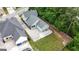 Aerial view of a home with a large driveway, backyard, and surrounding greenery at 100 Rabbits Run, Fayetteville, GA 30214