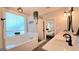 Bright bathroom featuring a soaking tub, double vanity, and glass enclosed shower leading to bedroom at 100 Rabbits Run, Fayetteville, GA 30214